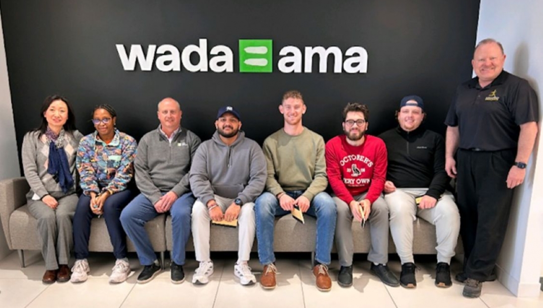 A group of people in front of a WADA sign
