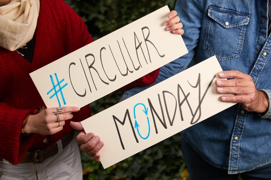 people hold signs marking #CircularMonday