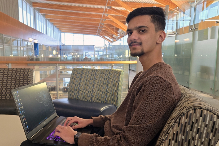 image of Vansh Patel seated with laptop