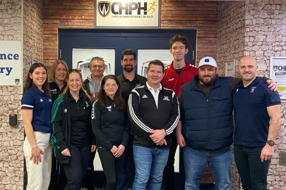 A group of people in front of the door for the Centre for Human Performance and Health