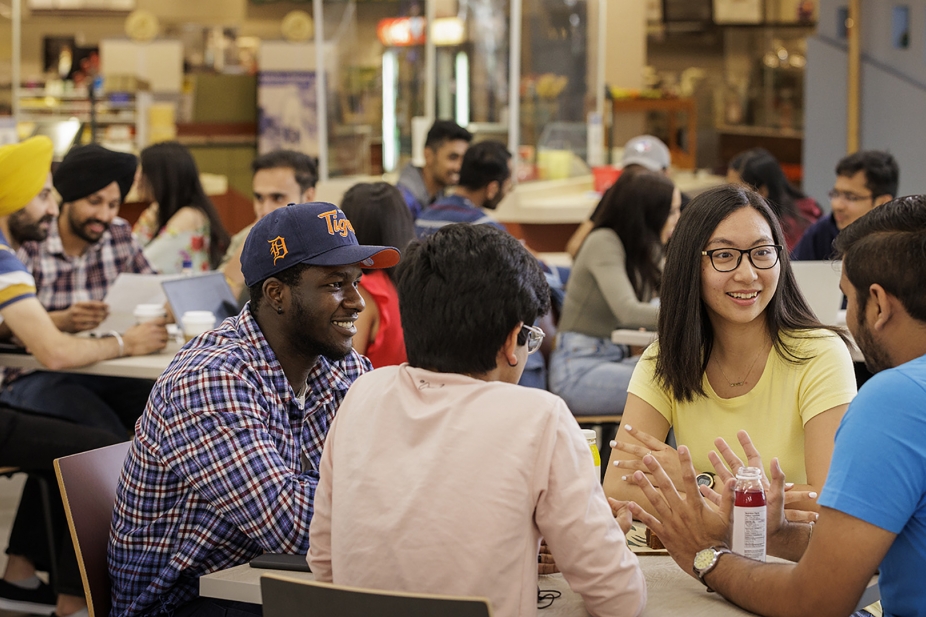 Student sitting in dining facility.