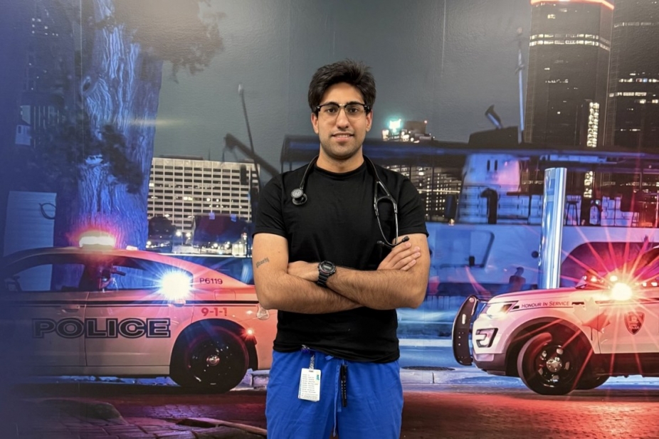 Ali Mozafari stands in front of two emergency vehicles during training at CAF base in Windsor.