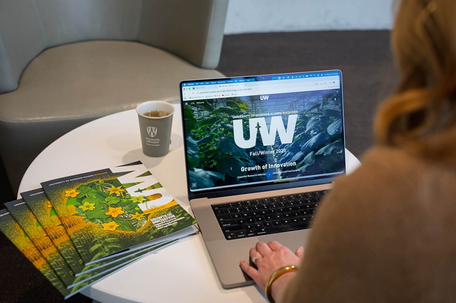 Digital edition of Alumni Magazine on a laptop.