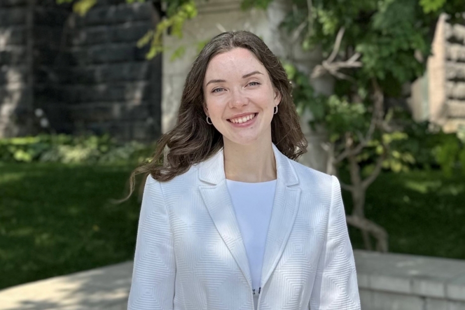 Rebecca Balasa stands outside in a green space