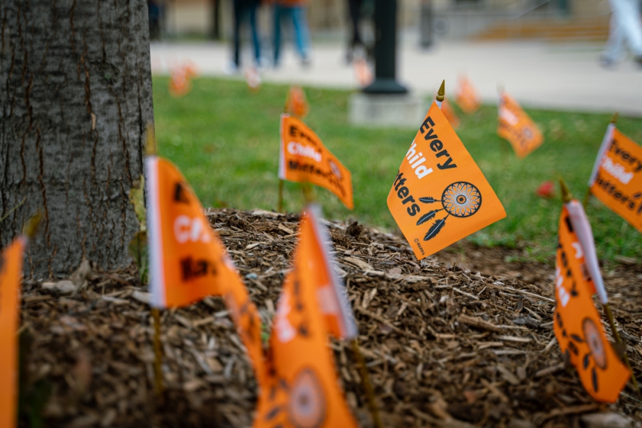 Closeup of Every Child Matters flags planted along Turtle Island Walk