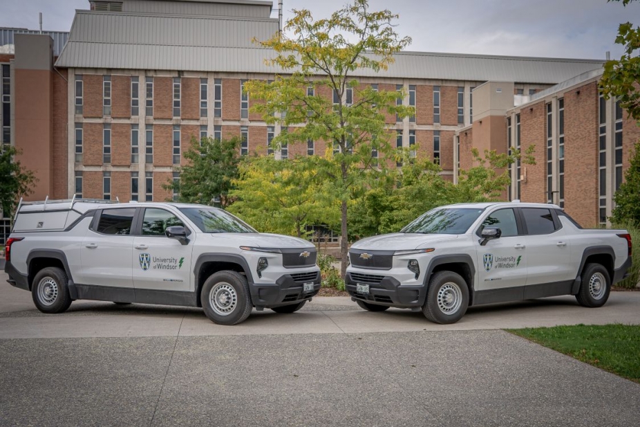 Two electric pick-up trucks parked on UWindsor campus