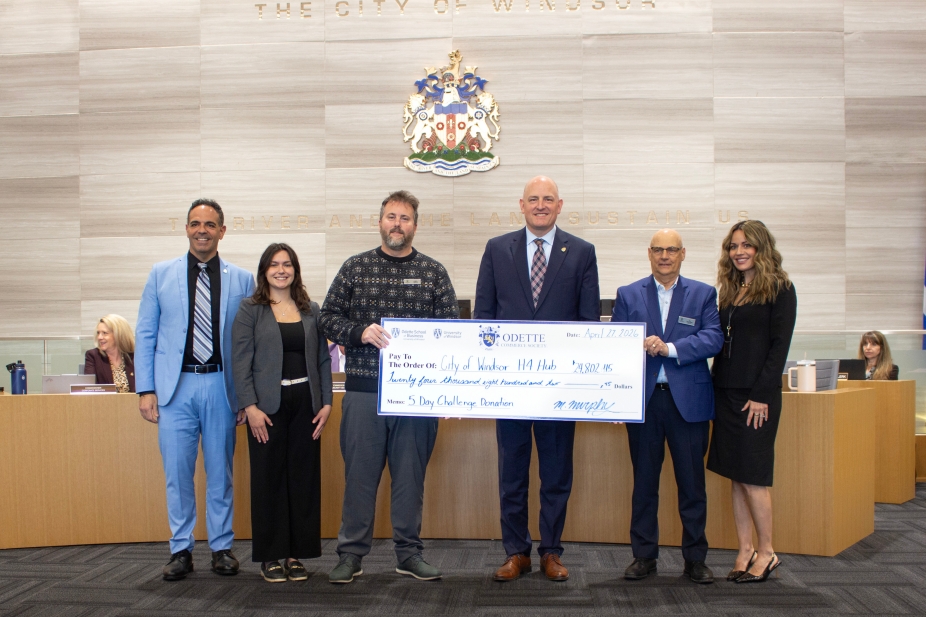 photo of members of City Hall, Odette School of Business and the Farrow Family Foundation holding the donated cheque