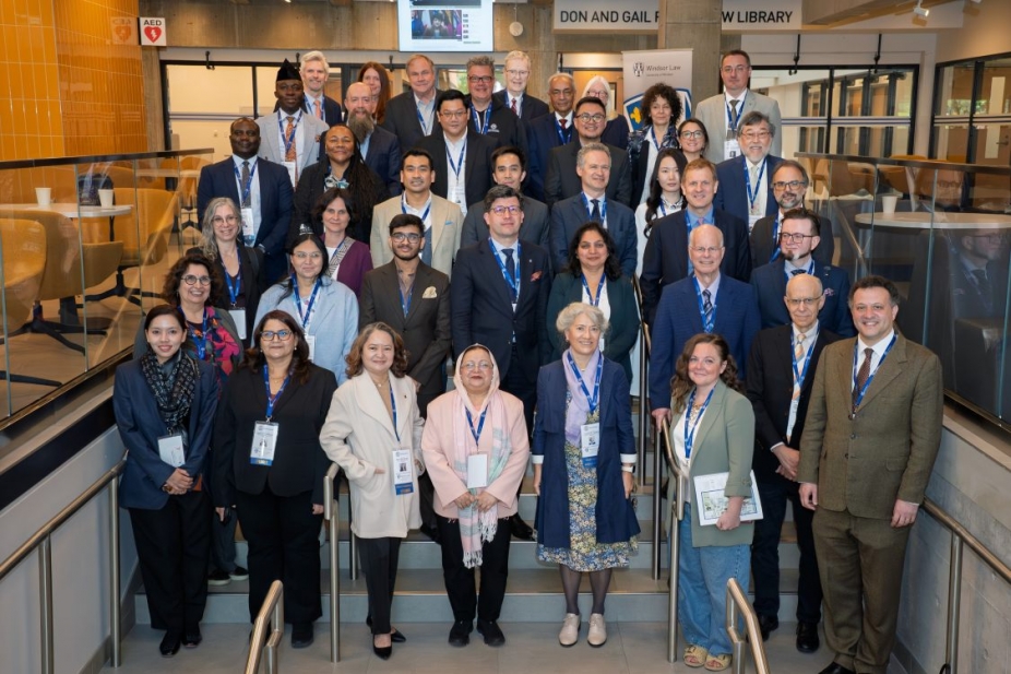 Deans from around the world stand together in the Ianni law building at UWindsor