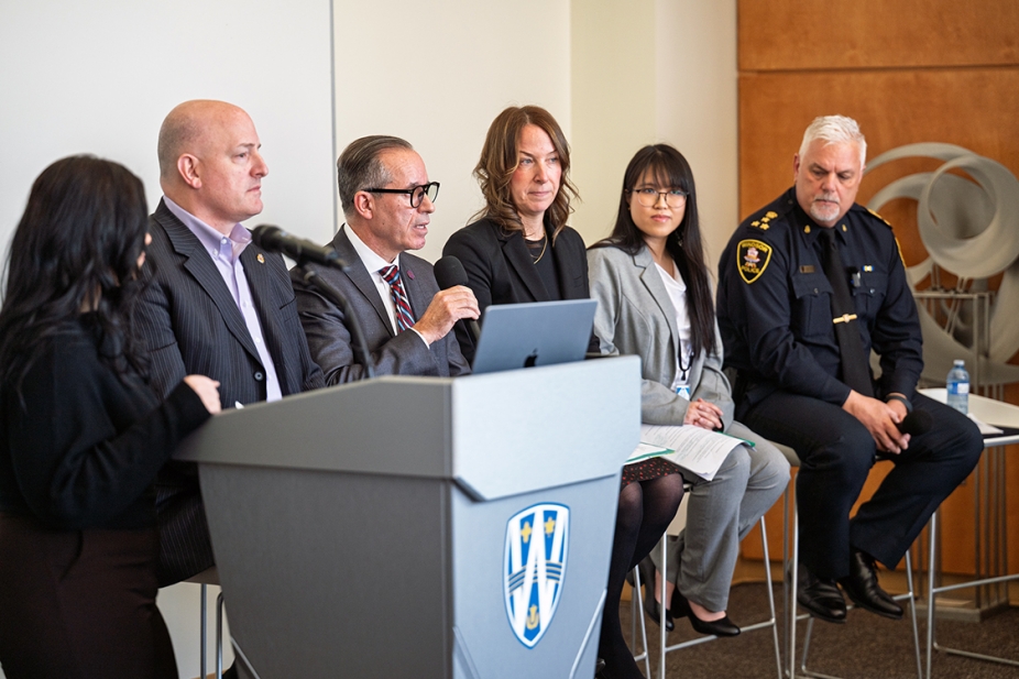 guest speakers seated speaking to audience