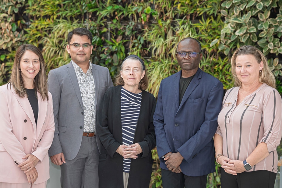 Members of the IJEDID Circle stand in front of greenery background in the Nursing Faculty building on UWindsor campus