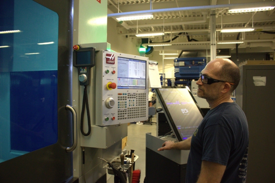 Technician using 3D printing machine at UWindsor