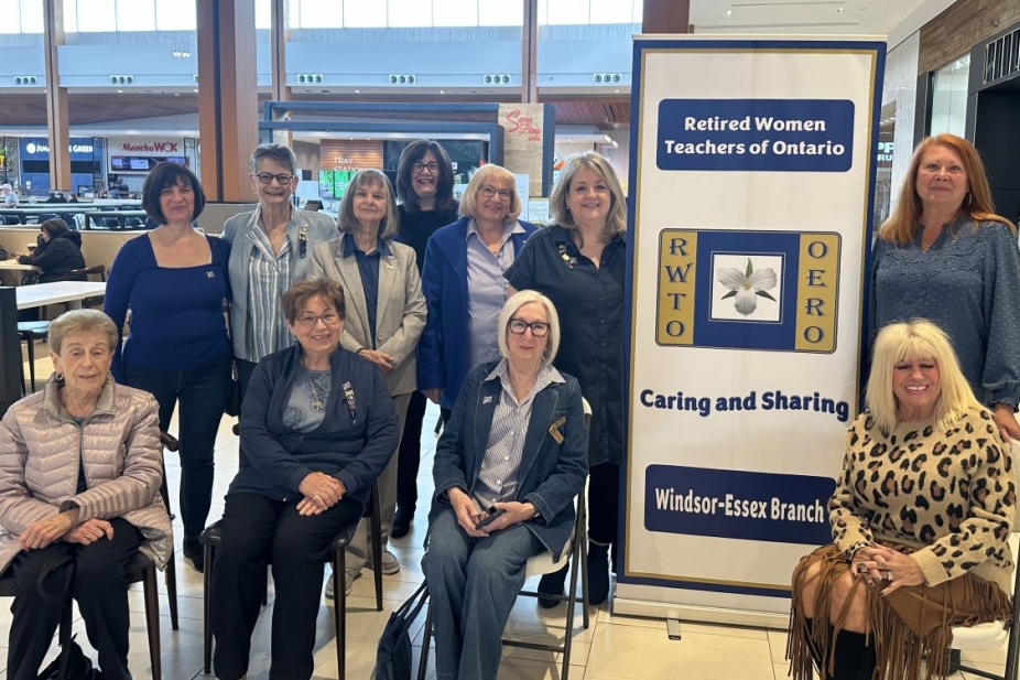 A group of women with a banner for the Retired Women Teachers' Organization