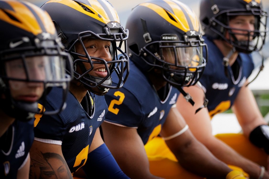Four football players in helmets