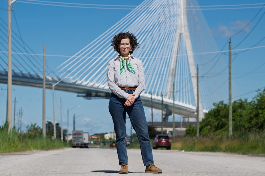 photo of Dr. Lee Rodney standing in front of the new Gordie Howe Bridge