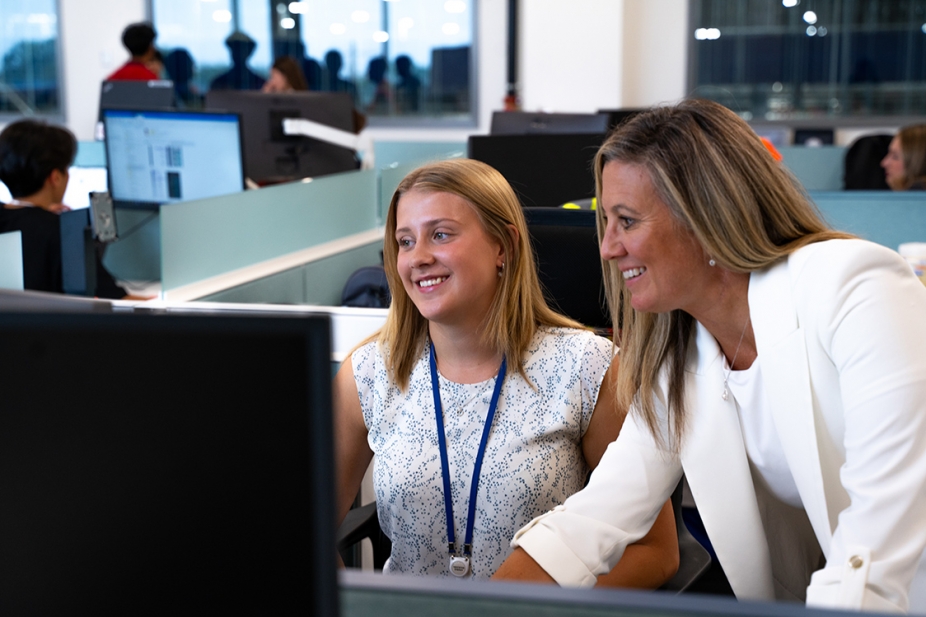 student and instructor seated at a computer