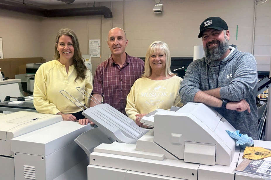 Print Shop staff pose with equipment.