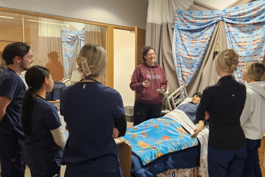 Sara Williams stands with students in an an Indigenous simulation clinic