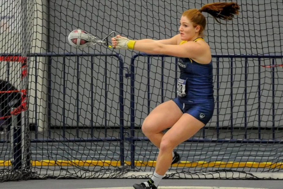 Sarah Mitton in Lancer jersey competing at shot put