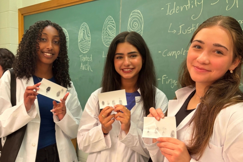 Three students in lab coats