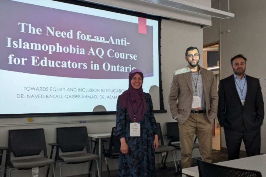 Asma Ahmed, Naved Bakali and Qaiser Ahmad in front of a projector screen with presentation slide about importance of AQ course
