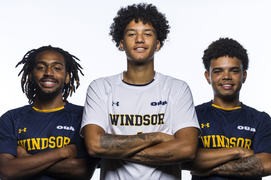 Lancer athletes standing together with arms crossed.