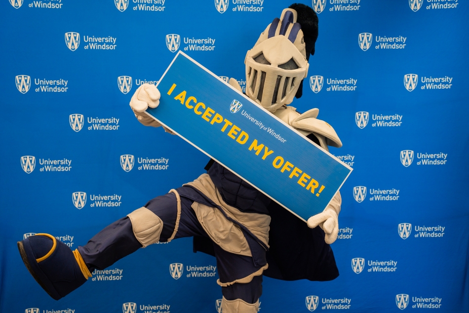 Winston posing with I Accepted My Offer placard.