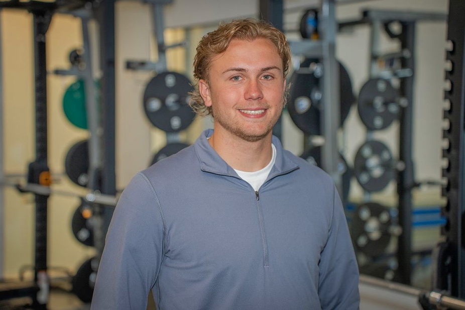 Brett Bjorgan in front of a rack of weights