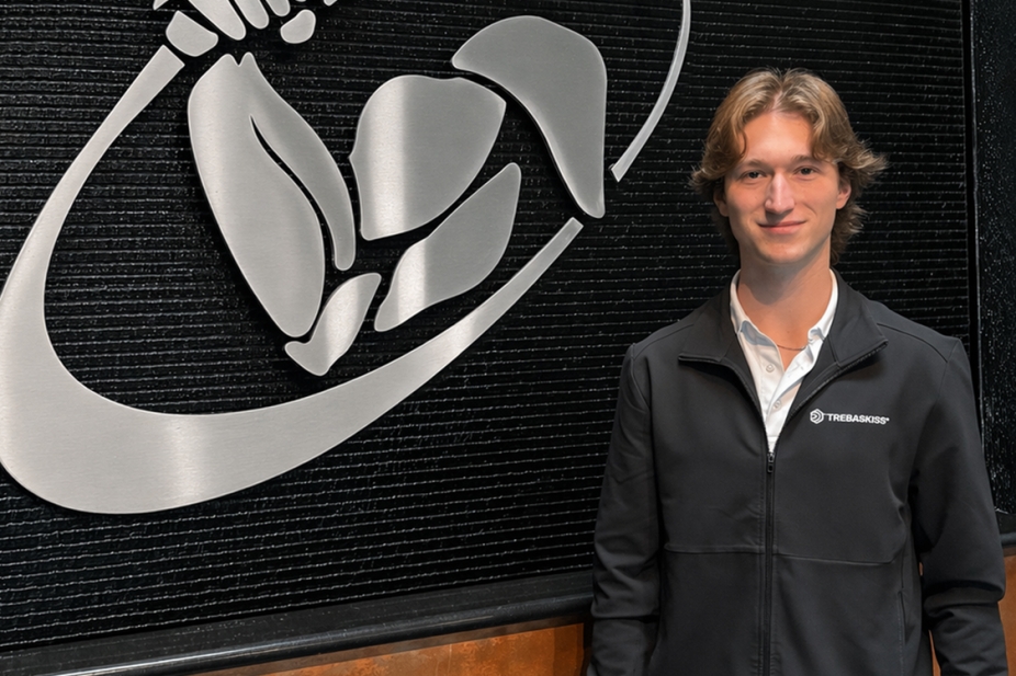 photo of Tyler Ballard standing next to the Tregaskiss logo