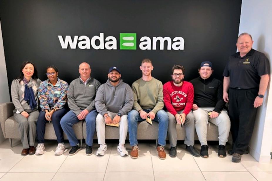 A group of people in front of a WADA sign