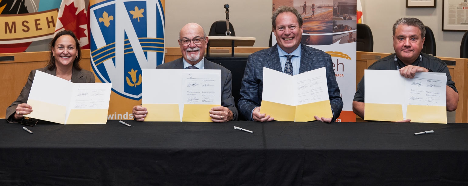 J.J. McMurtry and Gary McNamara hold signed documents