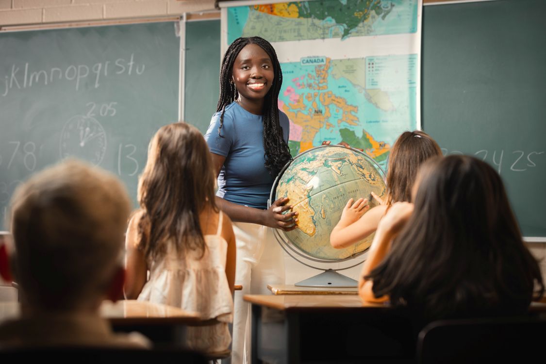 Student teacher in front of elementary school children