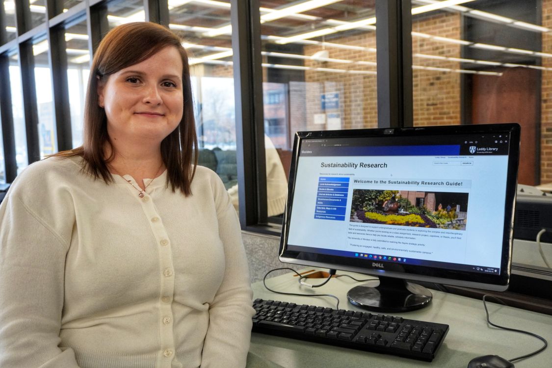 Annie Kavanagh with computer screen showing Sustainability research guide