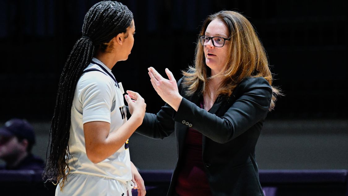 Chantal Vallee coaches Leah Tate (#24) during a women's Lancers basketball game 