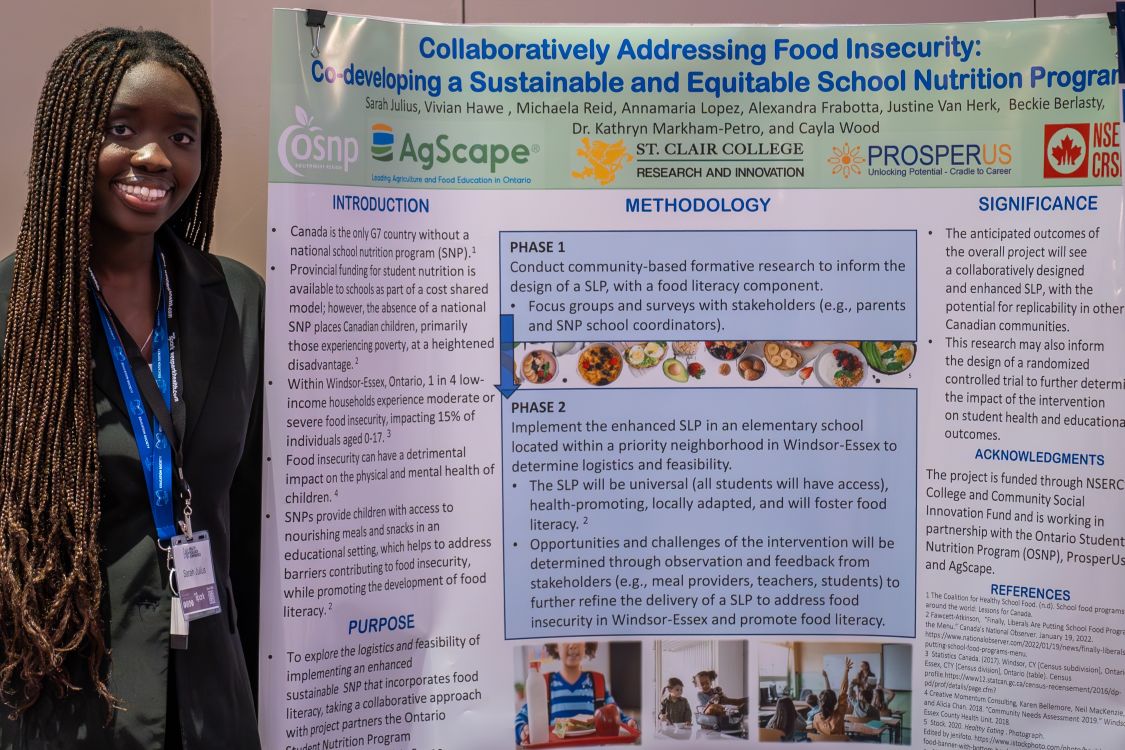 Sarah Julius with her research poster at We-Spark