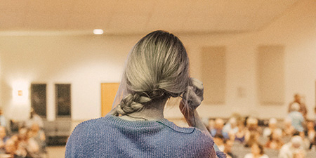 back view of female speaker