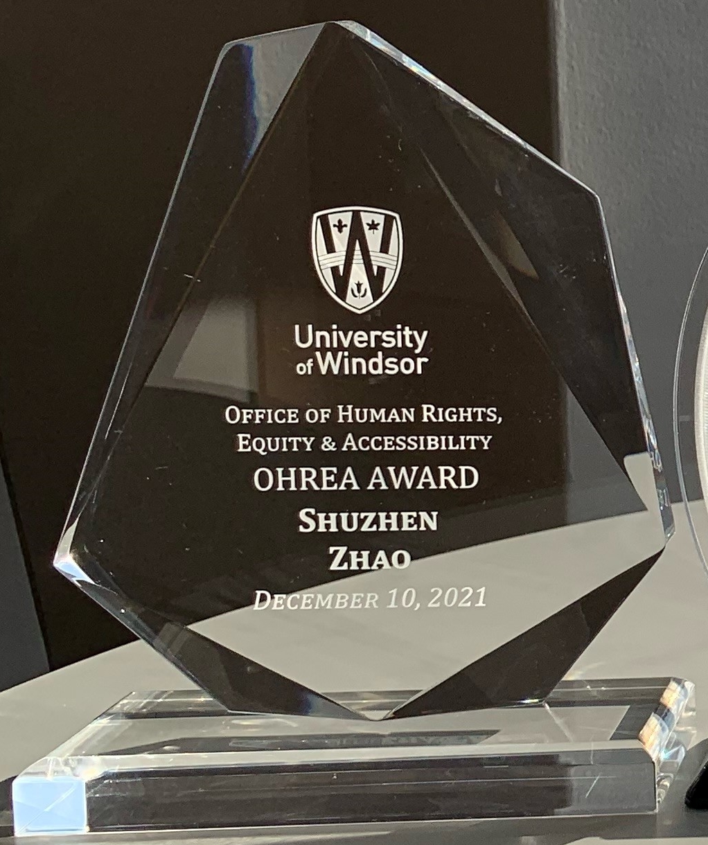 clear acrylic trophy presented to Shuzhen Zhao, OHREA Award