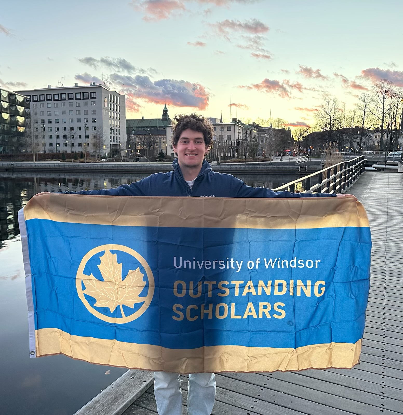 Jack Marcotte holding the Canadian flag at Jönköping University in Sweden