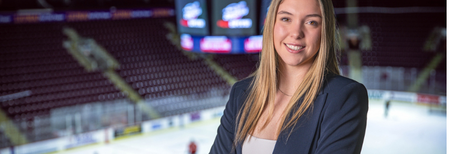 Student standing at the top of an ice hockey arena
