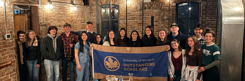 Students holding the Outstanding Scholars Flag