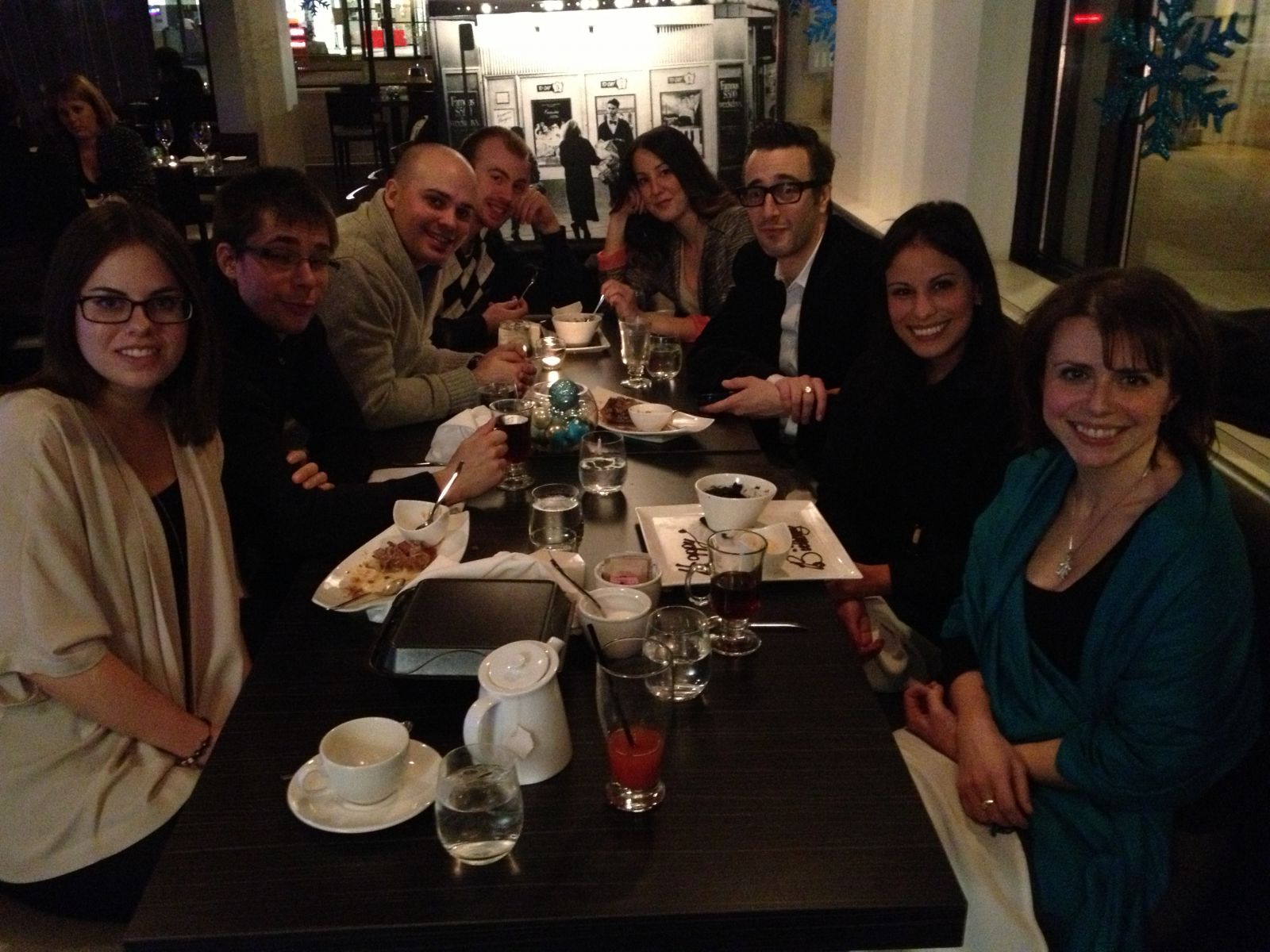 Group photo of Dr. Pascual-Leone and Alumni lab members at a table in a restaurant