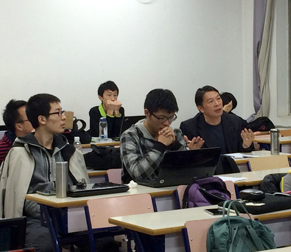 Dr. Ben C. H. Kuo participating in discussion while seated in a student desk