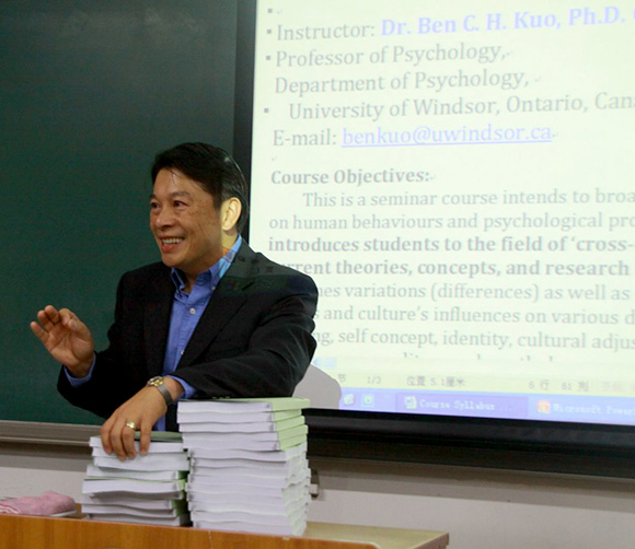 Dr. Ben C. H. Kuo speaking with projector screen in behind