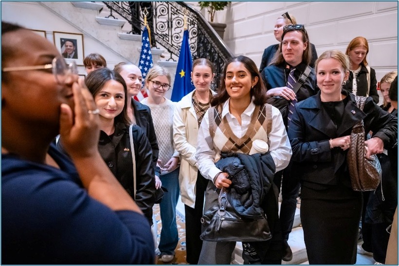 Group of students listening to a talk at the bottom of stairs in Brussels