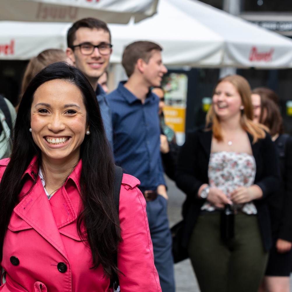 Students outside, highlighting one woman