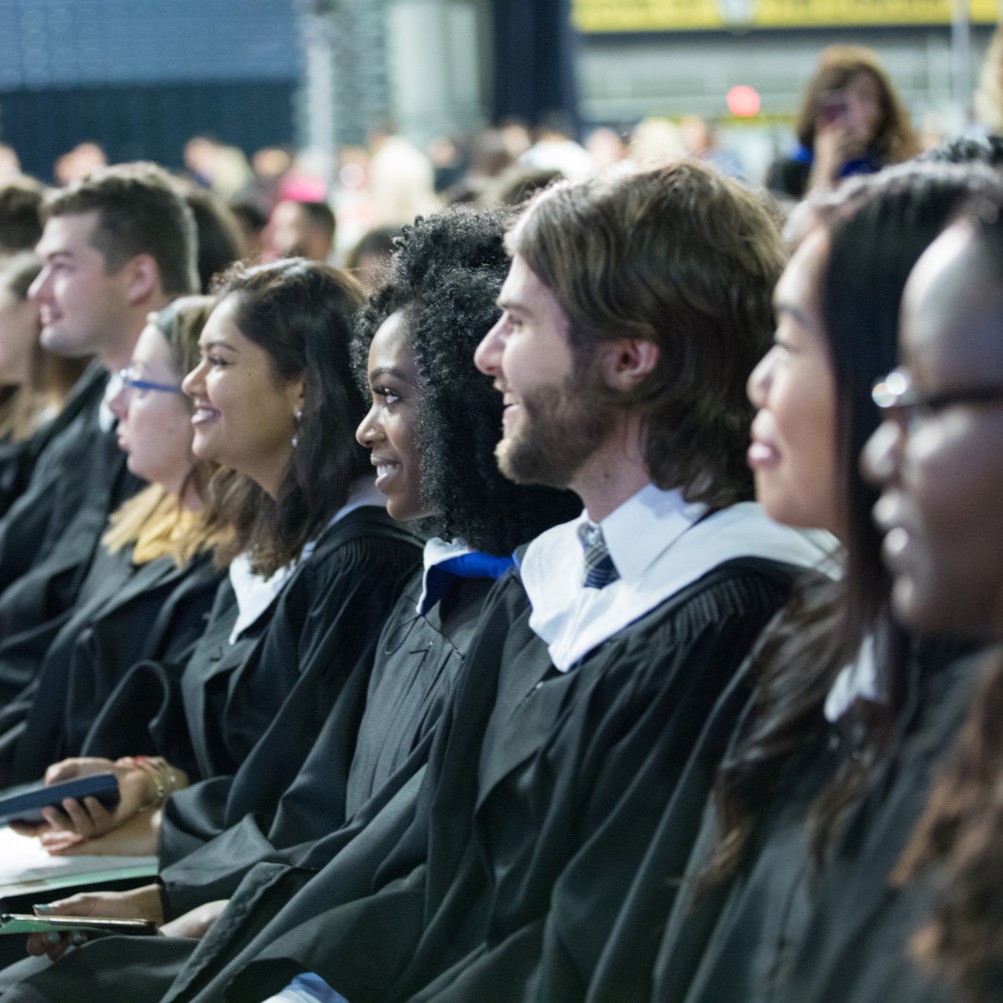 Students in graduate robes at convocation