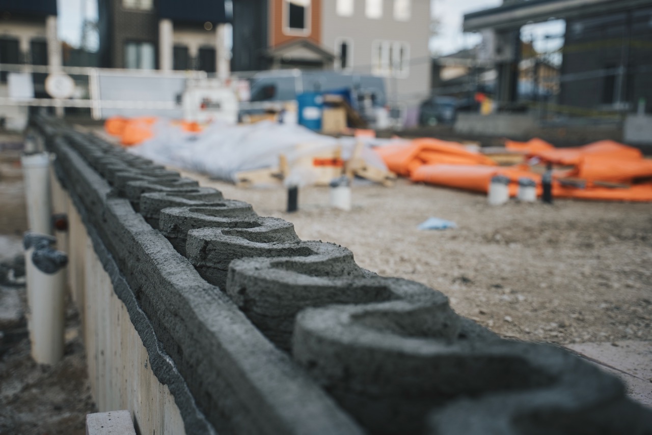 The first layers of Canada’s inaugural multi-storey 3D-printed student residence take shape as the printer lays down precision-formed concrete, marking a major early milestone in the University of Windsor housing project. (FILES/University of Windsor) 
         style=