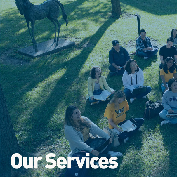 Students listen to professor Vincent Georgie during an outdoor lecture at the University of Windsor.