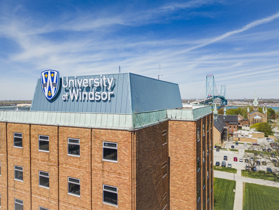 The University of Windsor's Residence Hall West is pictured with the Ambassador Bridge in the background.