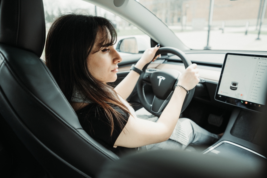 Noor Jajo, a research assistant in Dr. Francesco Biondi’s Human Systems lab sits behind the wheel of a Tesla used in recent research into driver attentiveness in semi-autonomous vehicles.