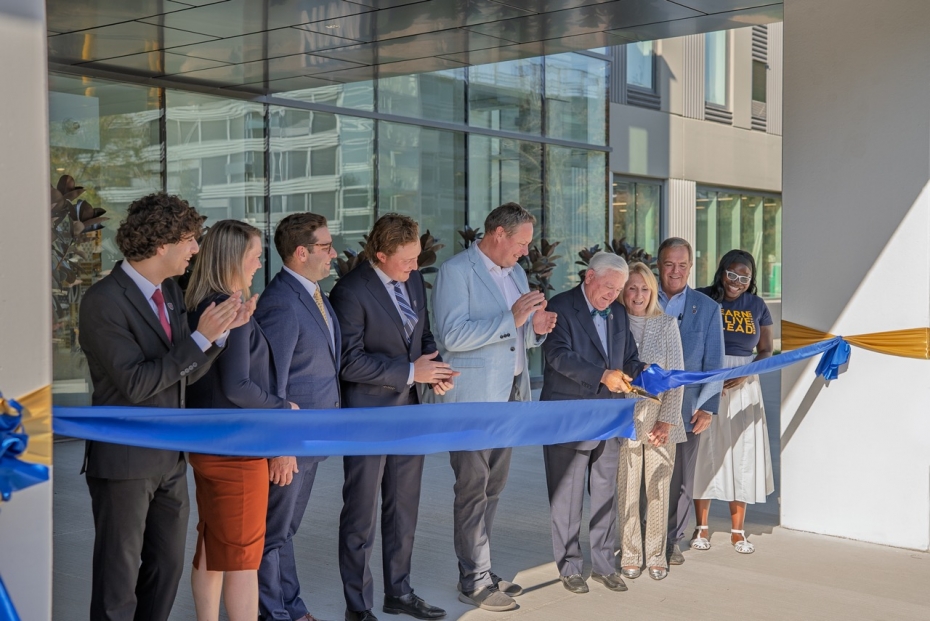Husam Morra, Gillian Heisz, Michael Kaye, Jack Federer, J.J. McMurtry, Don Rodzik Sr., Gail Rodzik, Dwight Duncan, and Promys Robinson cut a ceremonial ribbon to mark the official opening of Rodzik Hall, the University of Windsor’s newest student residenc